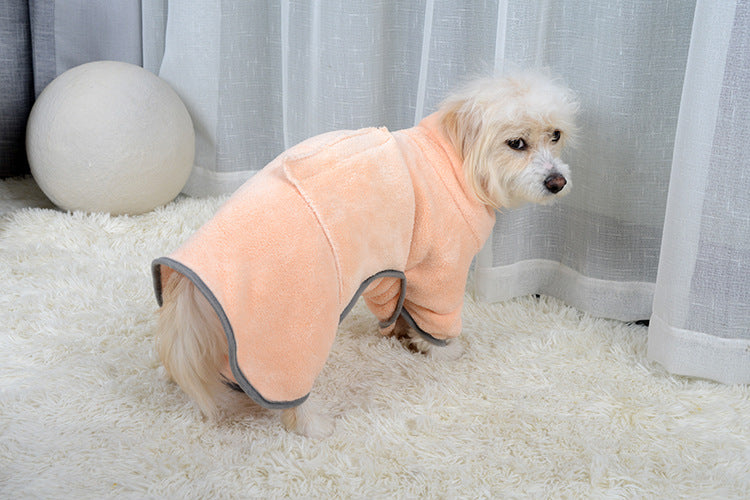 Dog wearing the pink drying robe, side view