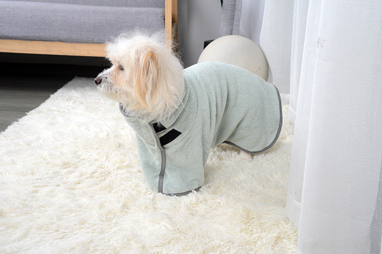 Dog wearing the green drying robe, side view